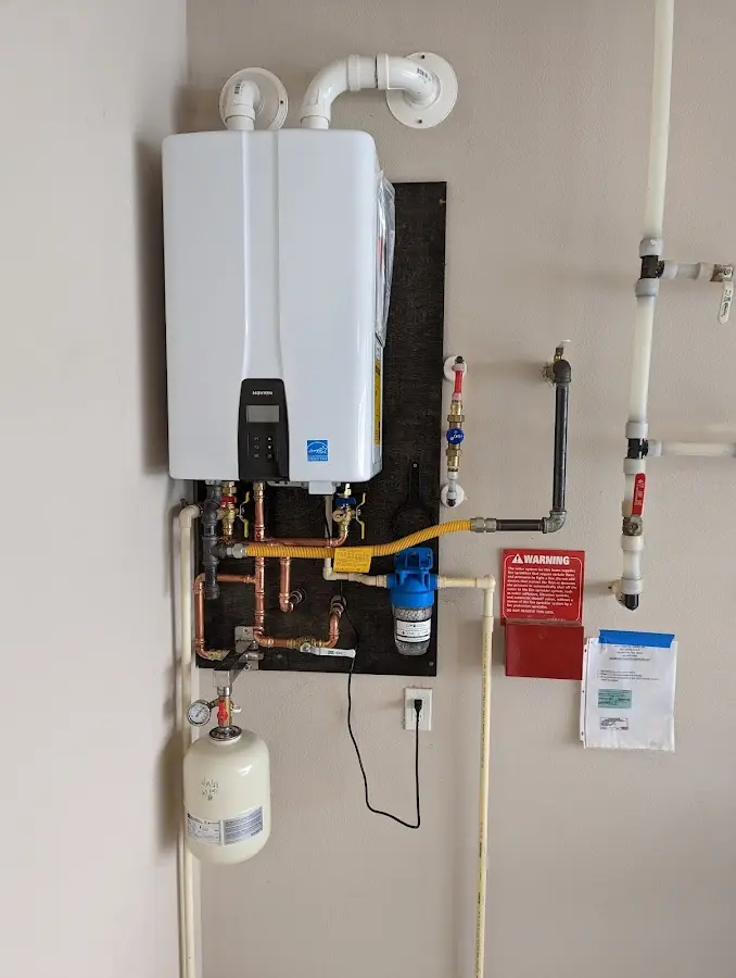 Professional plumber installing copper piping in a Wolverine Lake home